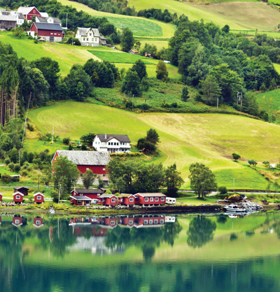 teaching in norway includes views of rolling green hills like this village in norway