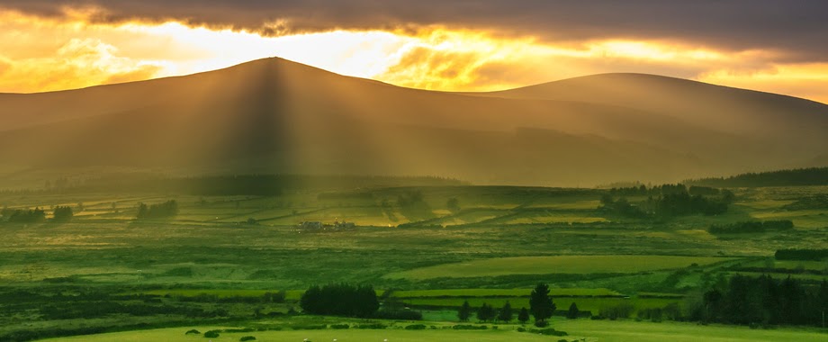 sunrise along ireland's green rolling hills 
