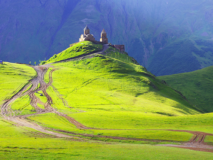 Rolling green hills and castle scenery in Georgia for ESL teachers to enjoy while teaching English in Georgia