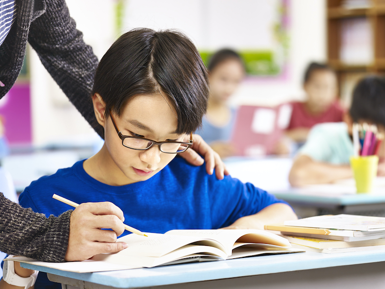 English language learner learning from an ESL teacher teaching English in China